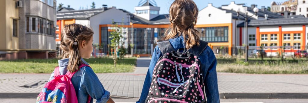 Children walking to school holding hands